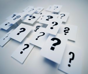 Multiple question marks on paper