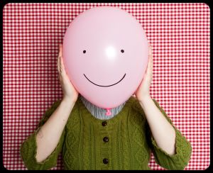 Female with balloon as face