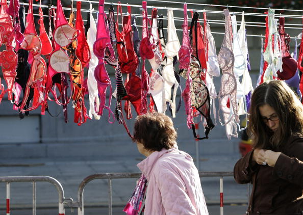 An elderly woman looks at the 1,500 bras