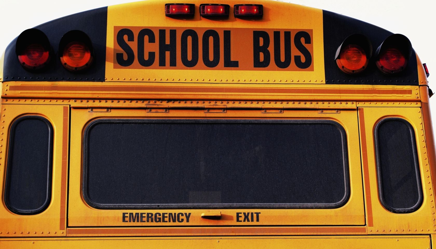 Front of yellow school bus, close-up, part of