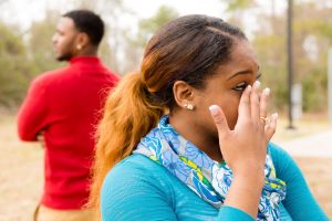 Conflict, arguement between African descent couple. Sadness, crying, anger.