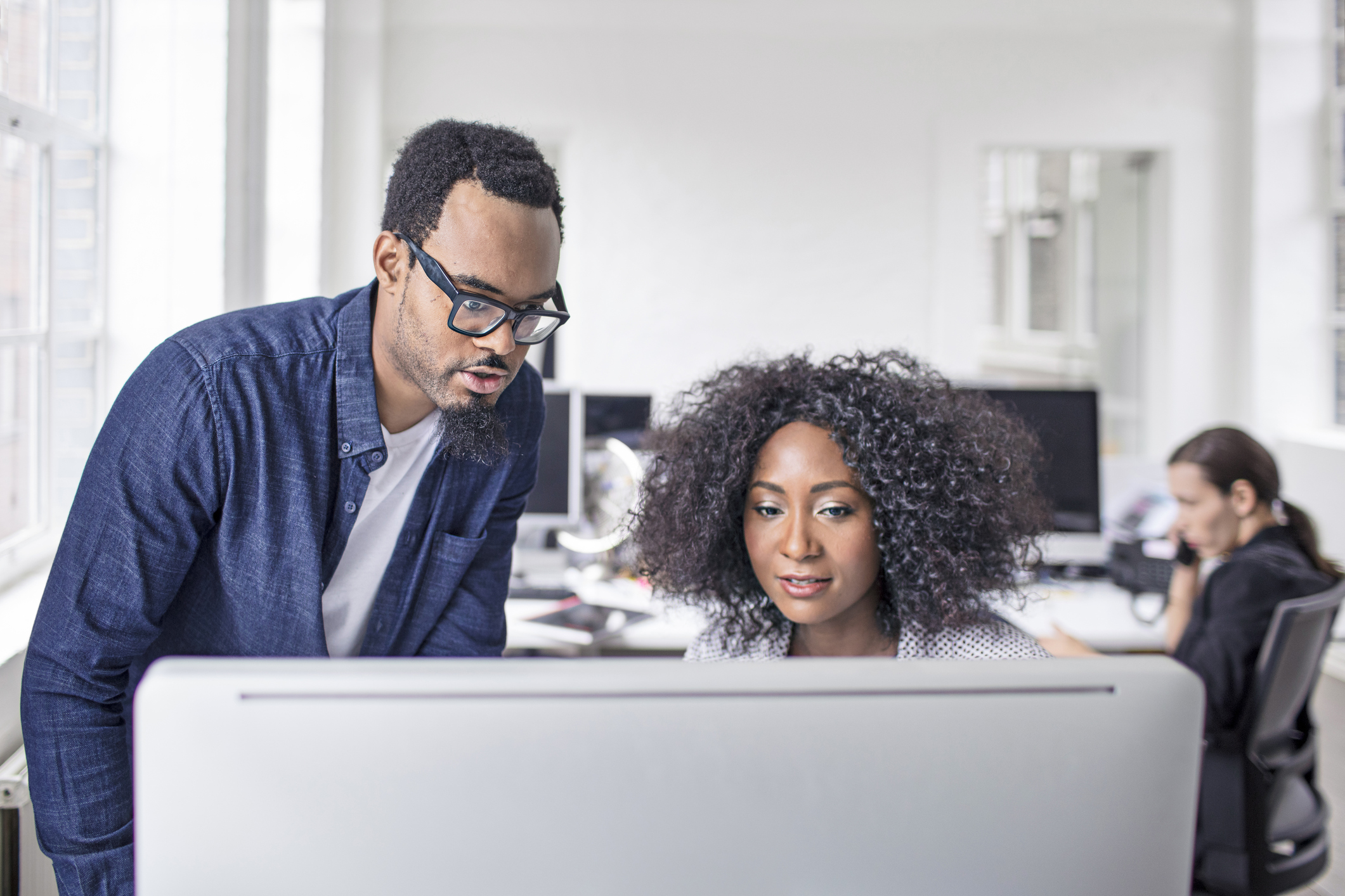 Business people using computer in new office