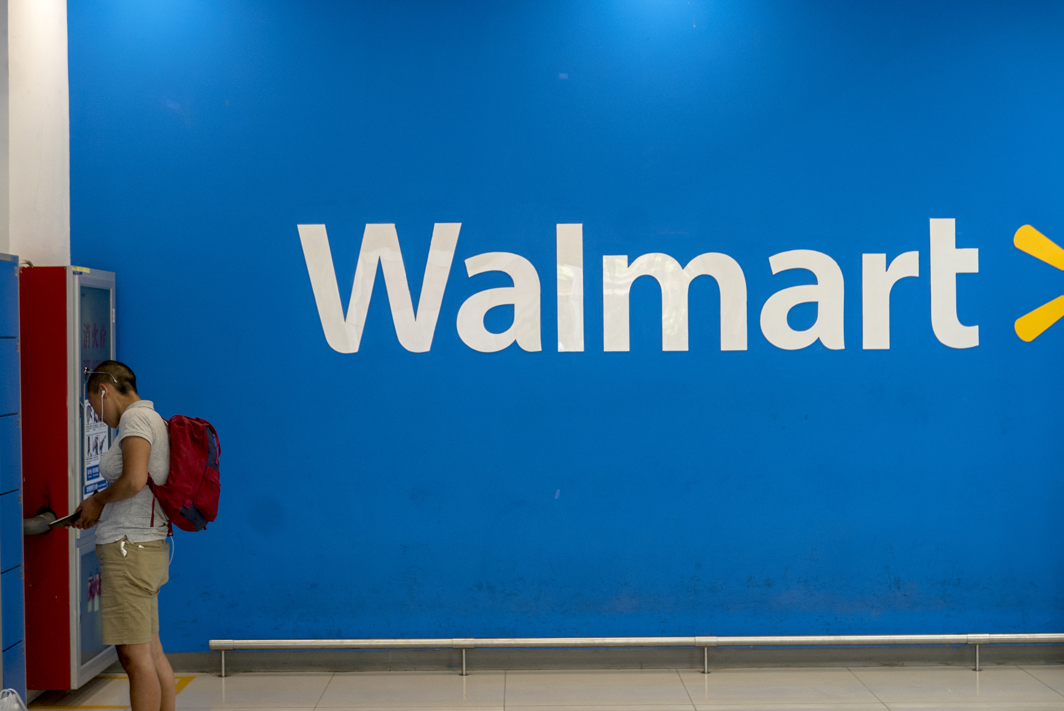 A man is taking his belongings in Walmart lockers.