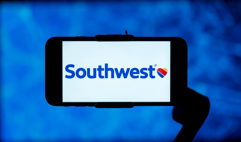 In this photo illustration, the southwest airlines logo is...