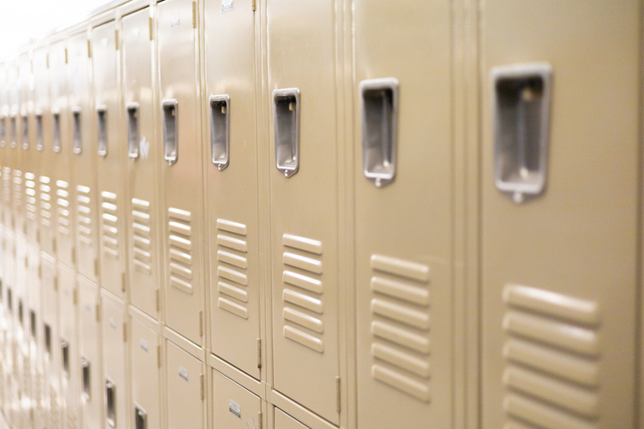 diminishing perspective of row of traditional metal school lockers