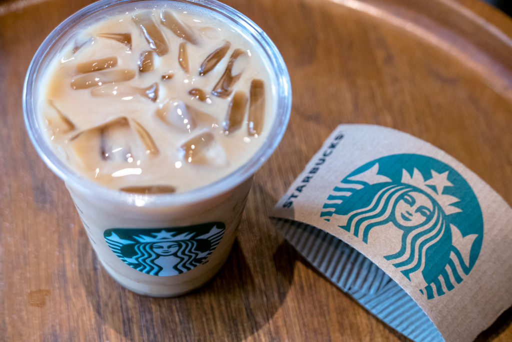 A cup of icy Starbuck coffee. Logo on a cup of Starbuck...