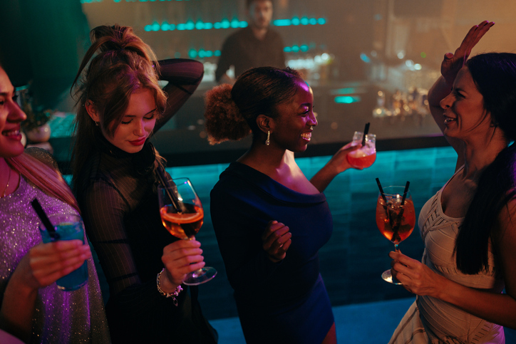 Girls in stylish clothes dancing on the dance floor.