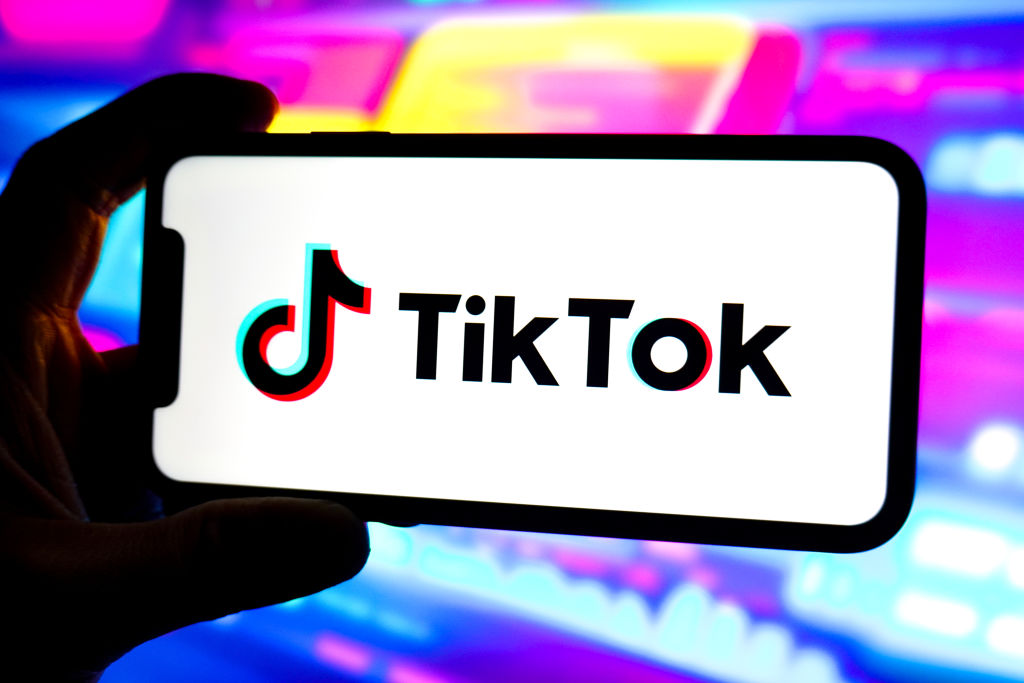 In this photo illustration, a Tik Tok logo is displayed on...