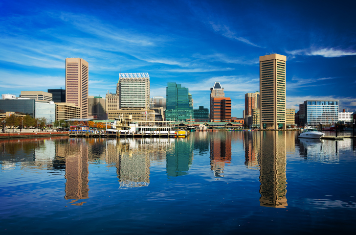 Baltimore Downtown Skyline With Harbor Reflections And Dramatic Skies
